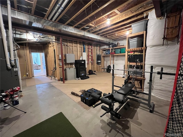 exercise room with concrete flooring and heating unit