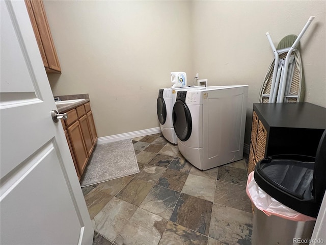 washroom with cabinets and washer and dryer