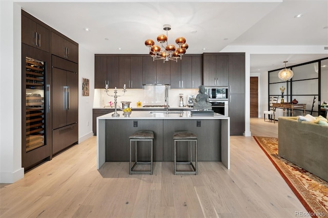 155 Steele St Unit 418, Denver, CO 80206 - kitchen with dark brown cabinets, light countertops, oven, modern cabinets, and built in refrigerator