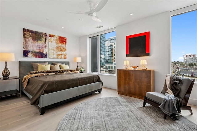 155 Steele St Unit 418, Denver, CO 80206 - bedroom with floor to ceiling windows, light wood-style floors, ceiling fan, and recessed lighting