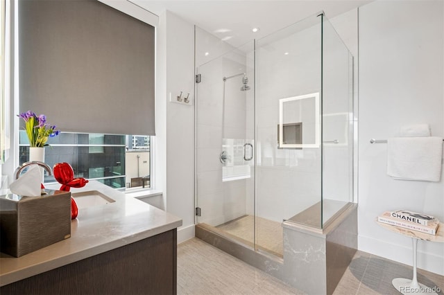 155 Steele St Unit 418, Denver, CO 80206 - bathroom featuring a shower stall, vanity, baseboards, recessed lighting, and tile patterned flooring