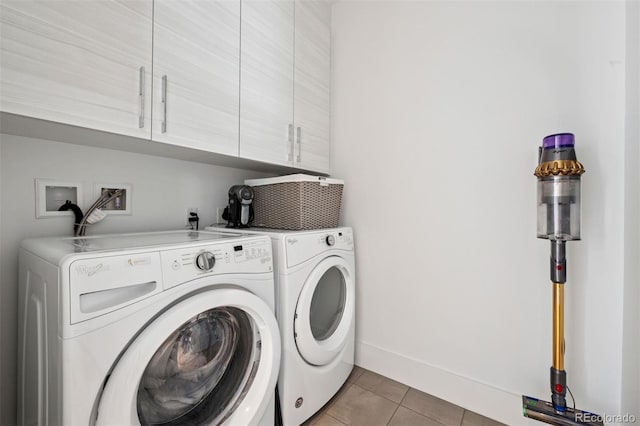 155 Steele St Unit 418, Denver, CO 80206 - laundry area with cabinet space, washer and dryer, light tile patterned floors, and baseboards