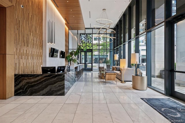 155 Steele St Unit 418, Denver, CO 80206 - community lobby with floor to ceiling windows, a towering ceiling, and wood walls