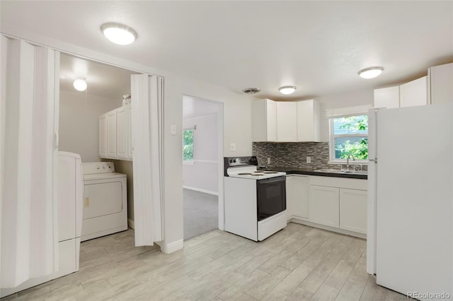 5455 Dudley Ct, Arvada, CO 80002 - kitchen with white appliances, washer / dryer, a sink, white cabinets, and light wood-style floors