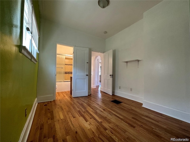 unfurnished bedroom with hardwood / wood-style flooring