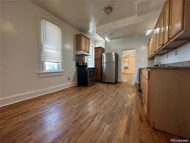 kitchen with appliances with stainless steel finishes and wood-type flooring