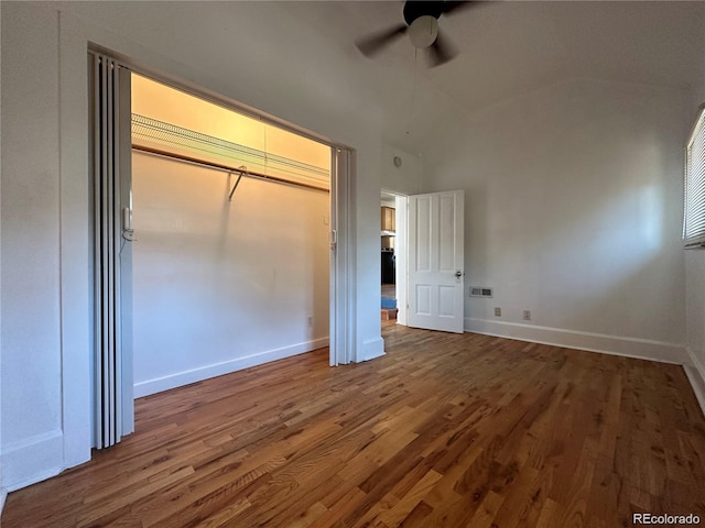 unfurnished bedroom featuring ceiling fan, a closet, and hardwood / wood-style flooring