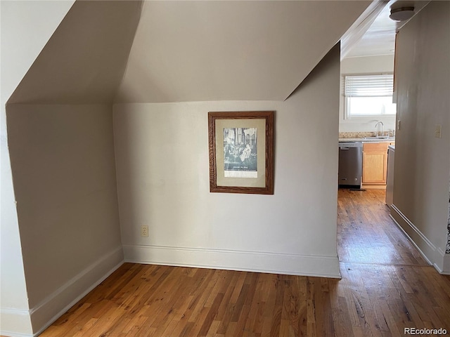 bonus room featuring sink, lofted ceiling, and wood-type flooring