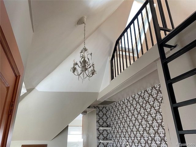 stairway with an inviting chandelier