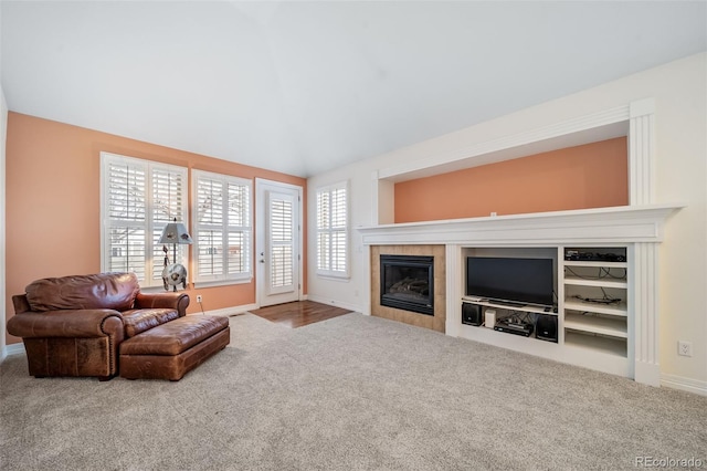 living room featuring carpet flooring and a tiled fireplace