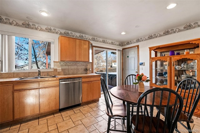 kitchen with a sink, tasteful backsplash, stainless steel dishwasher, and recessed lighting