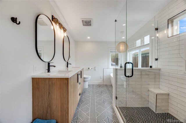 1055 Quartz St, Golden, CO 80401 - full bath featuring plenty of natural light, a shower stall, a freestanding bath, double vanity, and recessed lighting
