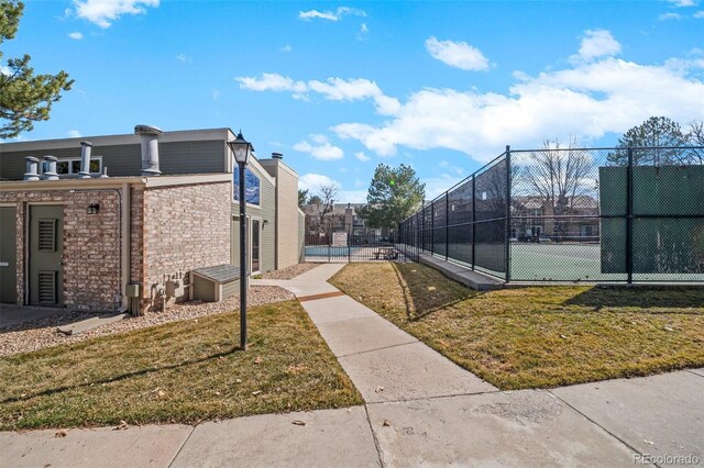 exterior space featuring a lawn and fence