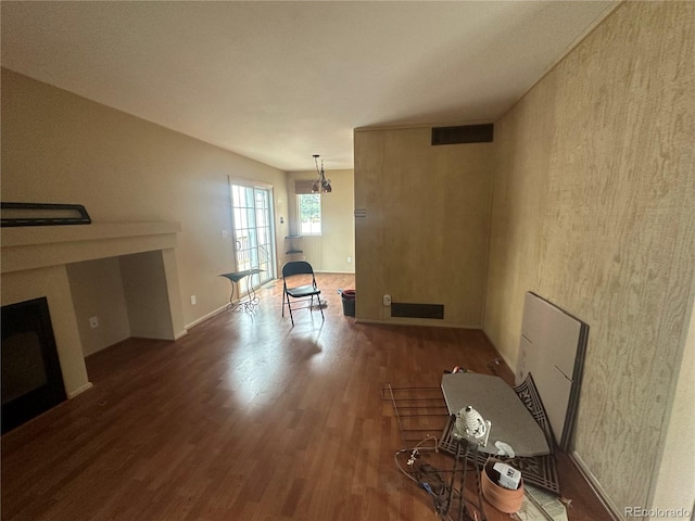 unfurnished living room featuring wood-type flooring and a fireplace