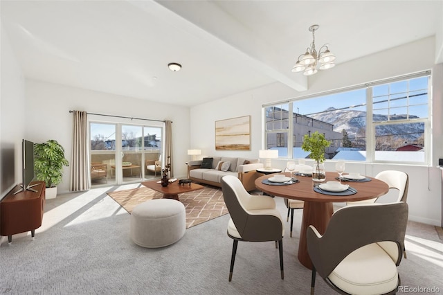 dining area featuring beamed ceiling, a mountain view, a chandelier, and light carpet