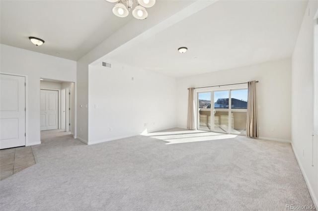 carpeted empty room featuring beamed ceiling and an inviting chandelier