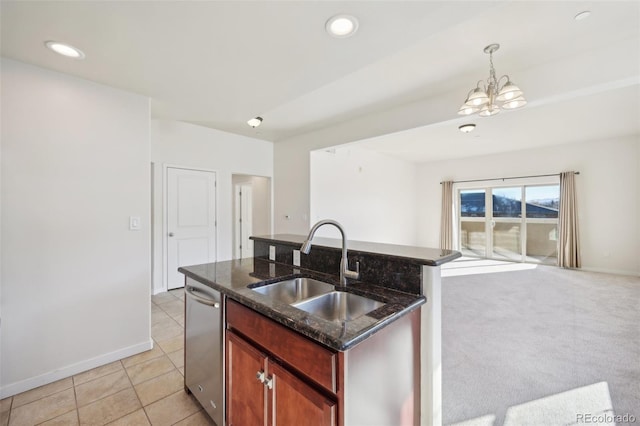 kitchen featuring sink, pendant lighting, an inviting chandelier, dishwasher, and an island with sink