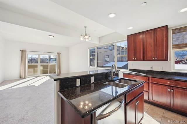 kitchen featuring sink, dishwasher, an inviting chandelier, light colored carpet, and a kitchen island with sink