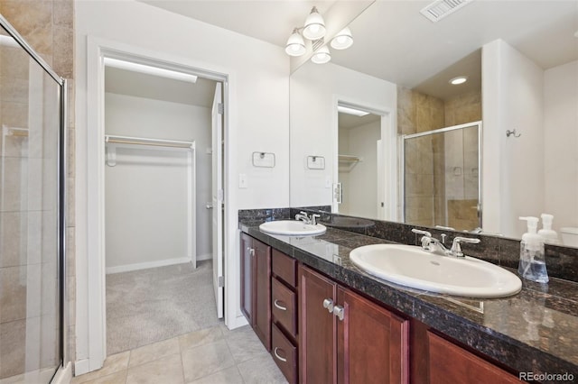 bathroom featuring tile patterned floors, vanity, and an enclosed shower