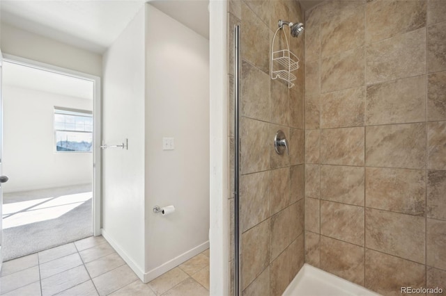 bathroom with tile patterned floors and tiled shower