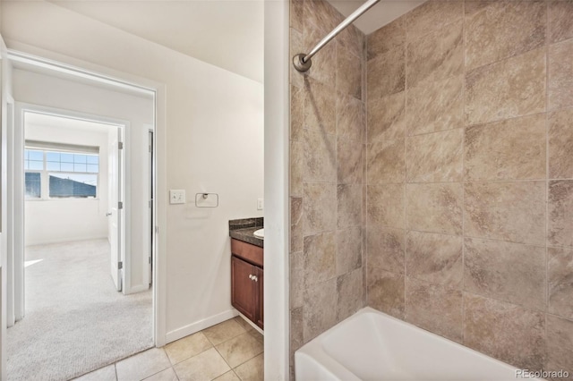 bathroom with tile patterned floors, vanity, and tiled shower / bath combo