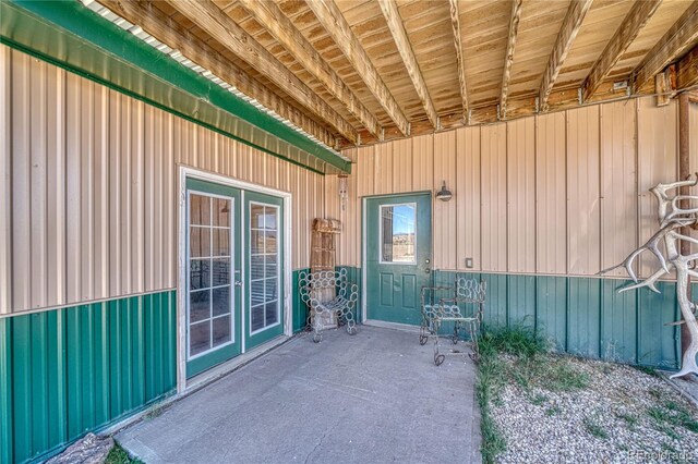 1120 County Road 322, Westcliffe, CO 81252 - view of exterior entry with board and batten siding and a patio area