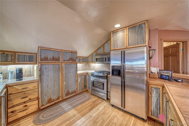 1120 County Road 322, Westcliffe, CO 81252 - kitchen featuring stainless steel appliances, light wood-type flooring, lofted ceiling, glass insert cabinets, and recessed lighting