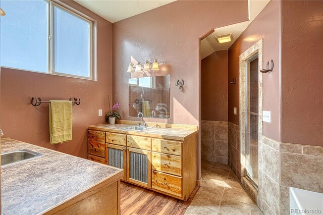 1120 County Road 322, Westcliffe, CO 81252 - full bath featuring vanity, a textured wall, a tub, an enclosed shower, and tile walls