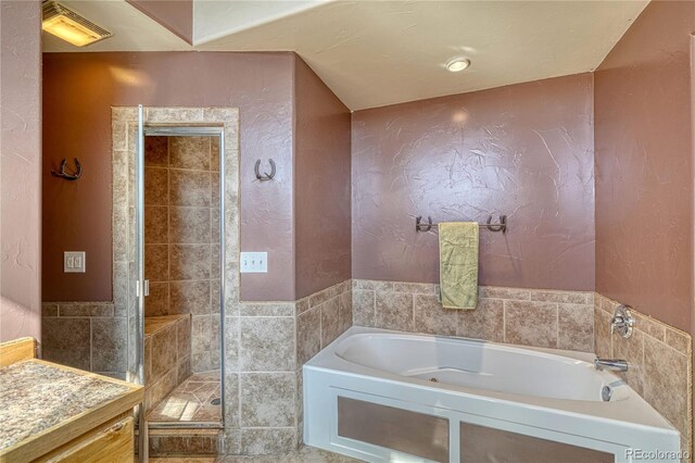 1120 County Road 322, Westcliffe, CO 81252 - bathroom featuring tile walls, a garden tub, and a shower stall