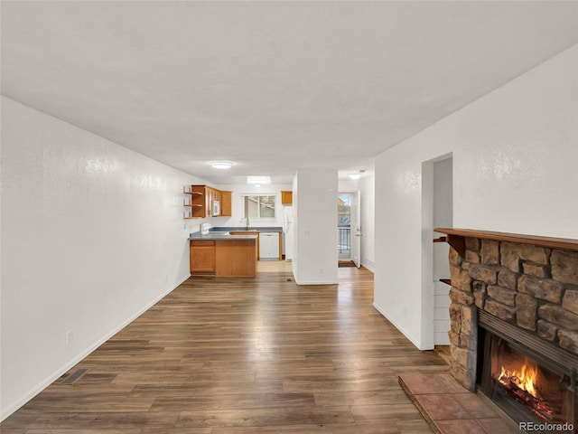 living room with dark wood-type flooring and a fireplace