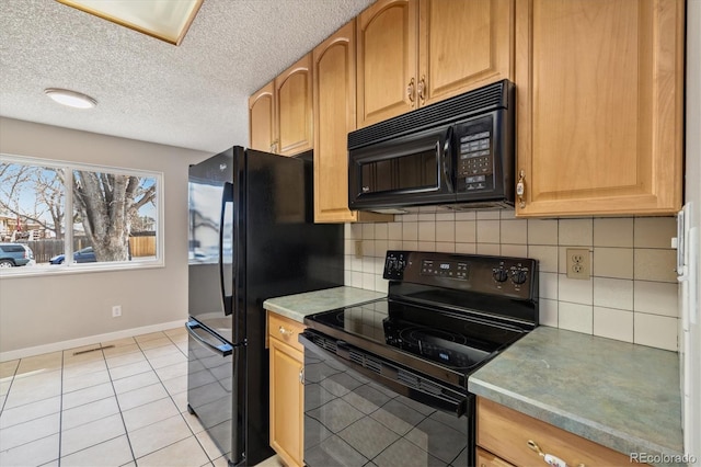 kitchen featuring light tile patterned floors, baseboards, black appliances, a textured ceiling, and tasteful backsplash