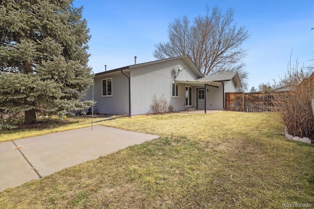 back of house with a patio, a lawn, and fence