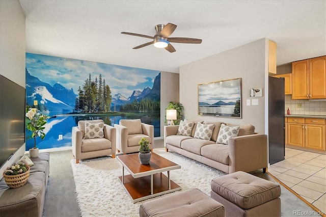living area with light tile patterned floors and ceiling fan