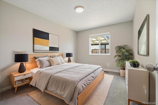 bedroom featuring light colored carpet and baseboards