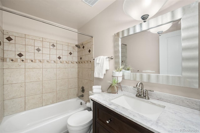 full bath with visible vents, toilet, vanity, and shower / tub combination