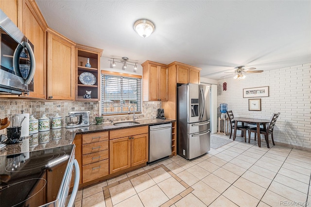 kitchen with light tile patterned flooring, appliances with stainless steel finishes, open shelves, and a sink