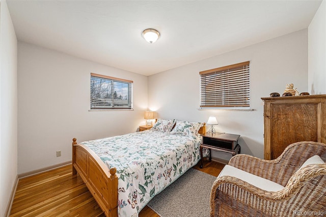 bedroom with baseboards and wood finished floors