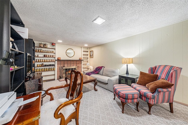 carpeted home office with a fireplace and a textured ceiling