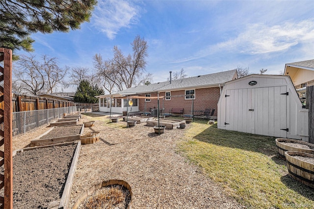 rear view of property featuring brick siding, a shed, an outdoor structure, and a garden