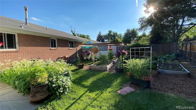 view of yard featuring a vegetable garden and fence