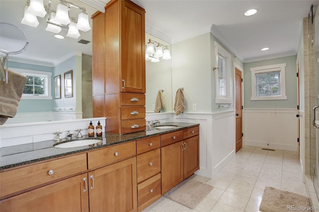 bathroom with walk in shower, tile patterned flooring, vanity, and ornamental molding