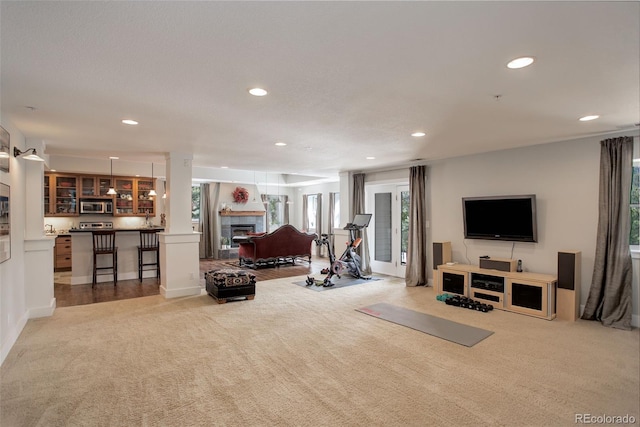 living room with light carpet and a tile fireplace