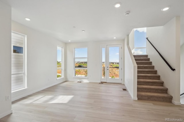 1257 Rhett Dr, Erie, CO 80026 - unfurnished living room with light wood-style floors, stairs, recessed lighting, and baseboards