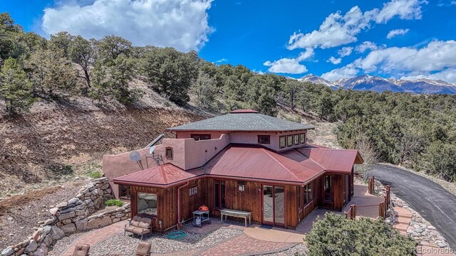 12220 Saddle Ridge Ln, Salida, CO 81201 - rear view of property with a view of trees, a patio area, and a mountain view