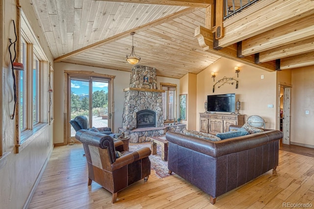 12220 Saddle Ridge Ln, Salida, CO 81201 - living room featuring a fireplace, light wood finished floors, baseboards, beamed ceiling, and wood ceiling