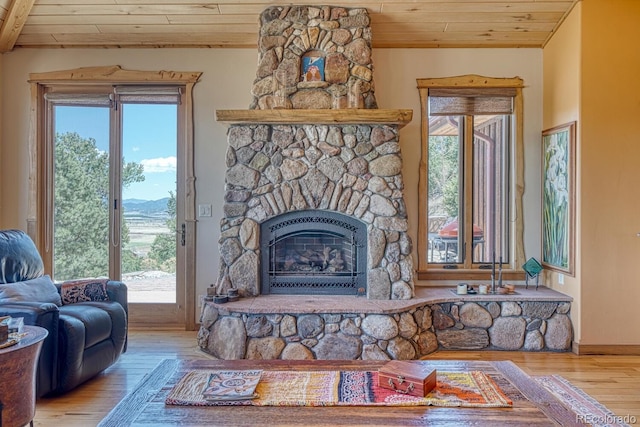 12220 Saddle Ridge Ln, Salida, CO 81201 - living area featuring wood ceiling, wood finished floors, healthy amount of natural light, a fireplace, and a mountain view