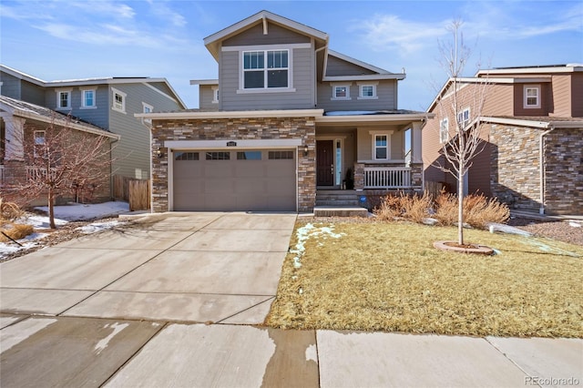 craftsman house featuring a porch, stone siding, and concrete driveway