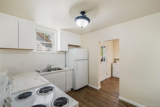 kitchen featuring sink, light stone countertops, white fridge, white cabinetry, and washer / clothes dryer