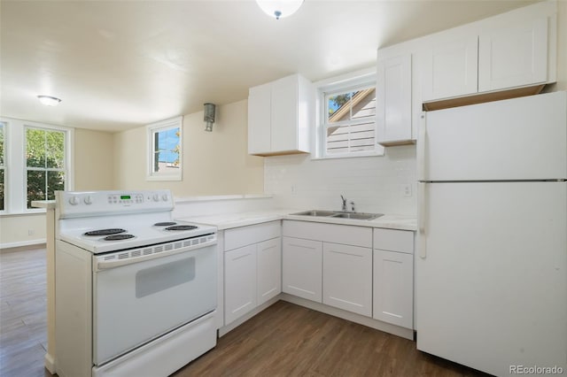 kitchen featuring kitchen peninsula, dark hardwood / wood-style flooring, white appliances, sink, and white cabinetry