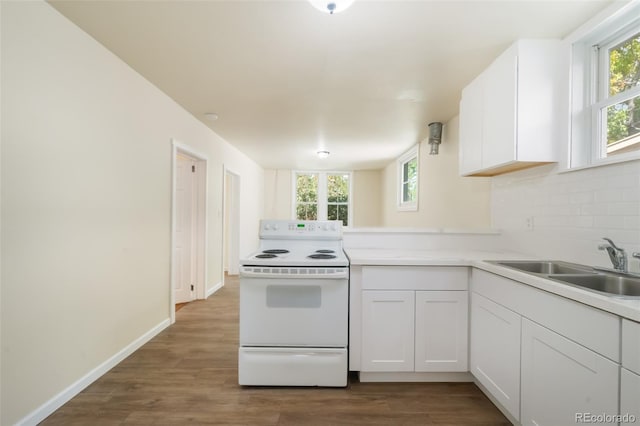 kitchen with white cabinetry, white range with electric cooktop, plenty of natural light, and sink